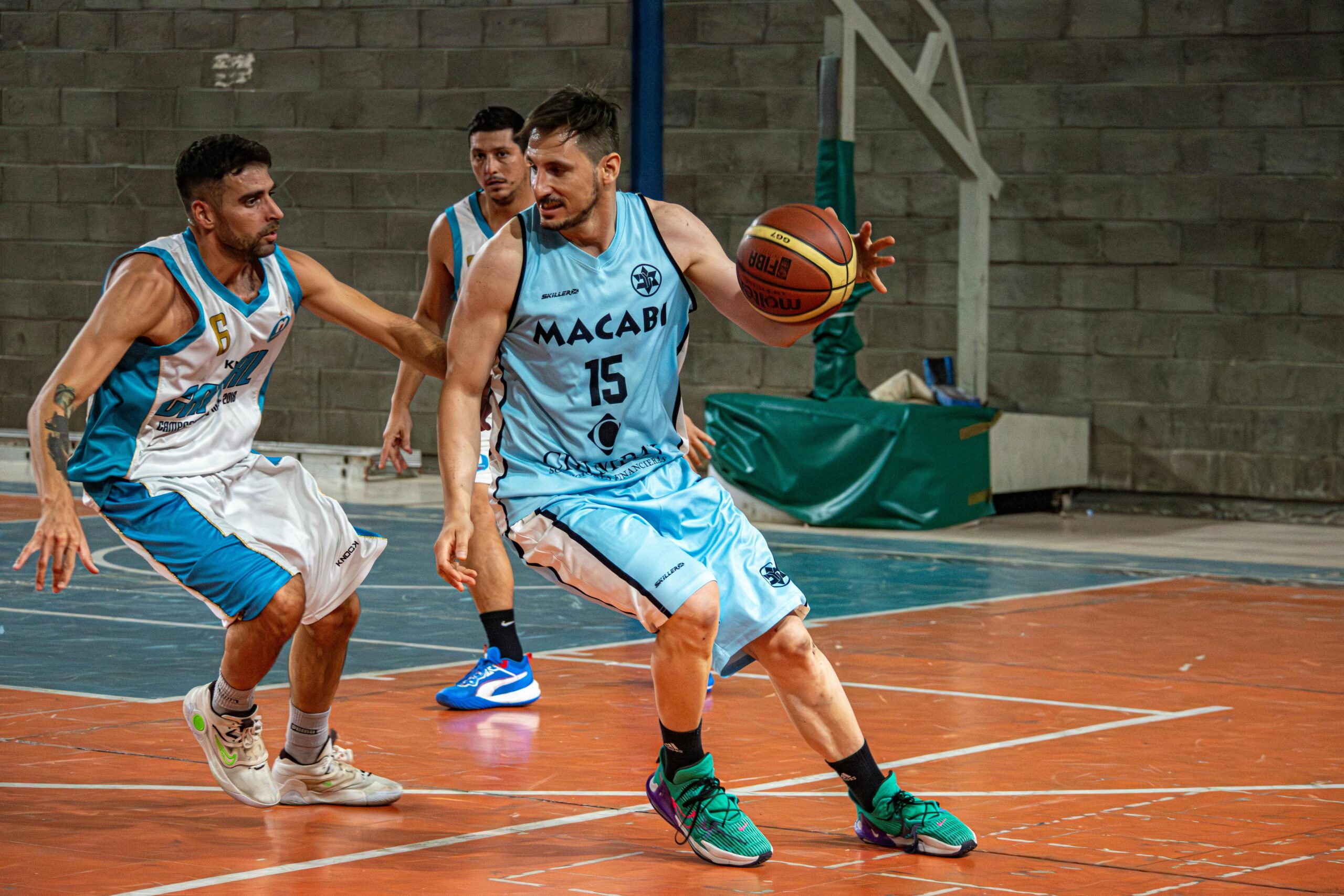 Dynamic shot of basketball players in action during an indoor game.